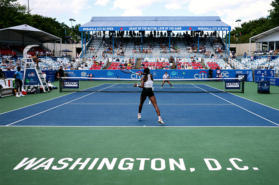 a woman playing tennis in a stadium